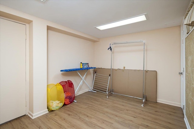 30 Nims Ave, West Babylon, NY 11704 - laundry room featuring wood finished floors and baseboards