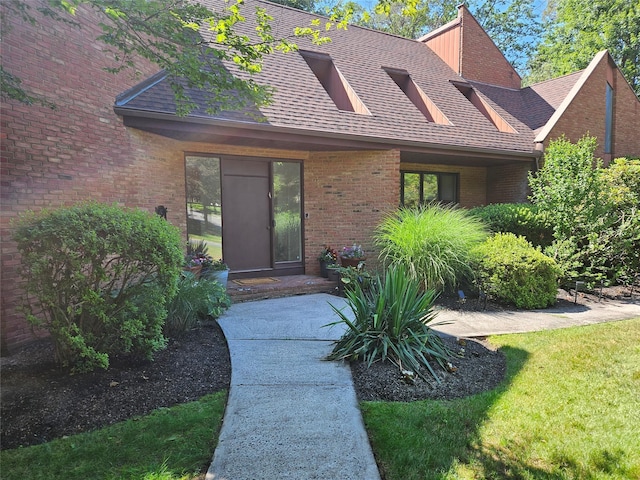 5 Sophia St, Monsey, NY 10952 - property entrance featuring brick siding, a shingled roof, and a yard