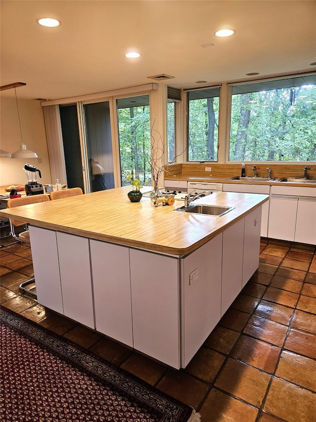 5 Sophia St, Monsey, NY 10952 - kitchen with white cabinets, an island with sink, recessed lighting, and butcher block countertops