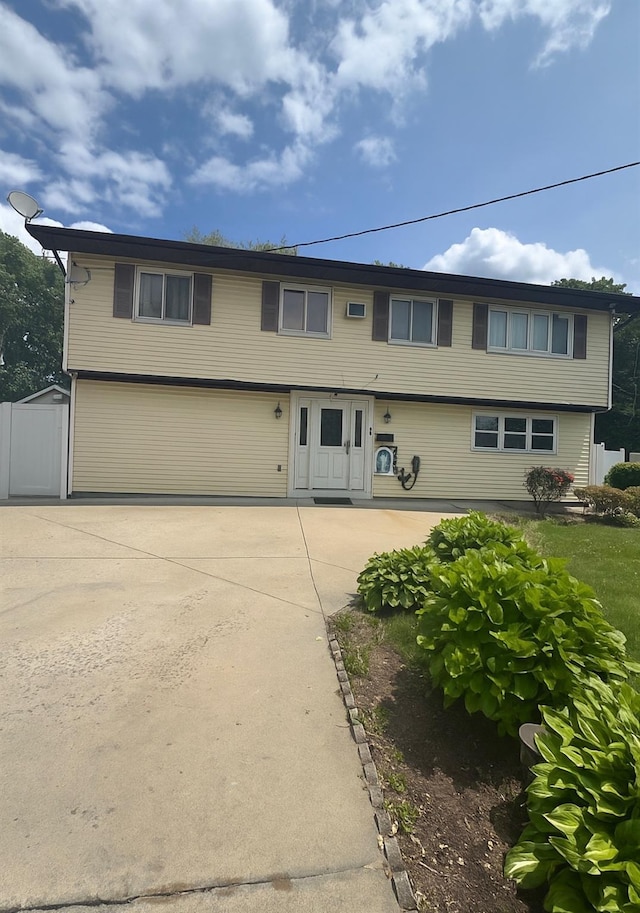 51 Ferris Ave, Brentwood, NY 11717 - colonial-style house with driveway, an attached garage, and a patio
