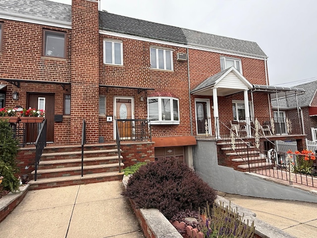 59-47 69th Ln Unit A, Maspeth, NY 11378 - view of property featuring brick siding, a chimney, and roof with shingles