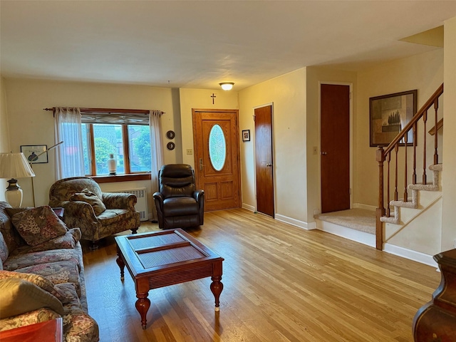 59-47 69th Ln Unit A, Maspeth, NY 11378 - living room with light wood-style flooring, stairs, and radiator heating unit