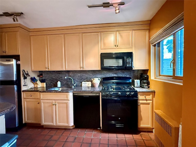 59-47 69th Ln Unit A, Maspeth, NY 11378 - kitchen featuring black appliances, tasteful backsplash, radiator heating unit, dark tile patterned floors, and dark stone countertops