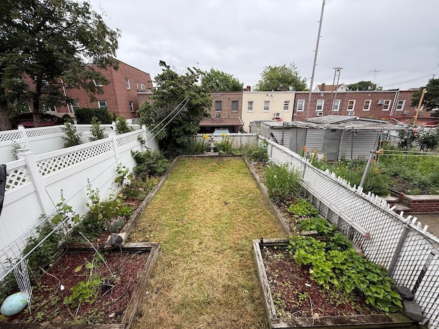 59-47 69th Ln Unit A, Maspeth, NY 11378 - fenced backyard featuring a garden