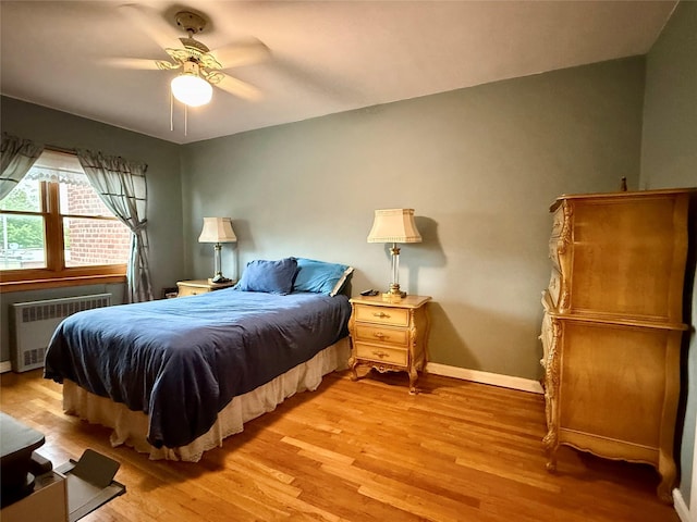 59-47 69th Ln Unit A, Maspeth, NY 11378 - bedroom featuring radiator, light wood-type flooring, and ceiling fan