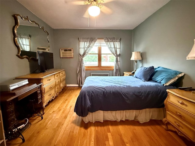 59-47 69th Ln Unit A, Maspeth, NY 11378 - bedroom with a wall mounted air conditioner, light wood-style floors, radiator, and ceiling fan