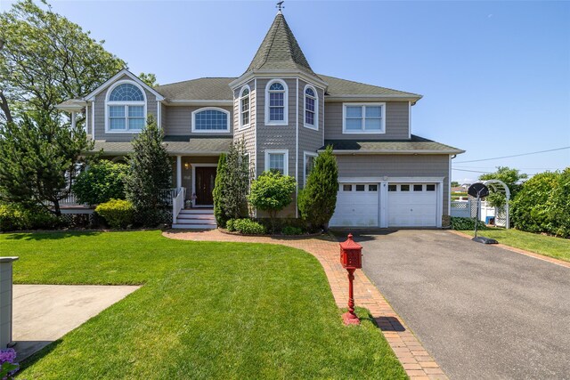 248 Delaware Ave, Island Park, NY 11558 - view of front of home with driveway, an attached garage, a front yard, and a shingled roof