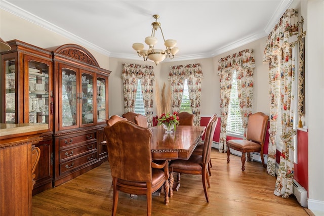 248 Delaware Ave, Island Park, NY 11558 - dining area with a chandelier, ornamental molding, wood finished floors, and baseboard heating