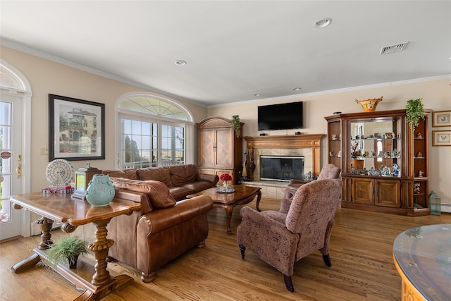 248 Delaware Ave, Island Park, NY 11558 - living area featuring wood finished floors, crown molding, a tiled fireplace, and recessed lighting