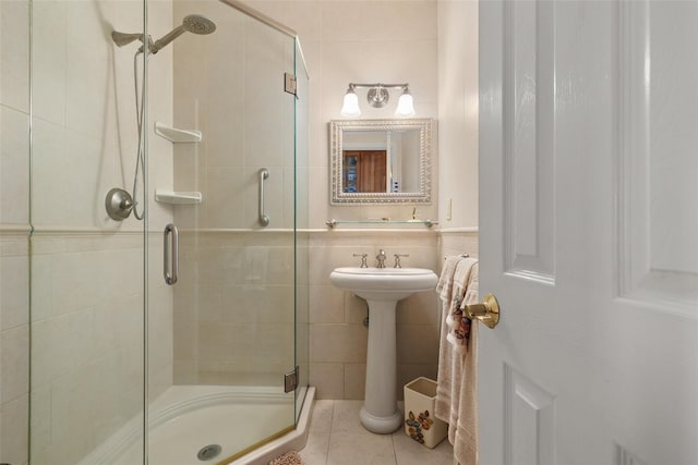 248 Delaware Ave, Island Park, NY 11558 - bathroom featuring tile walls, a shower stall, and tile patterned flooring