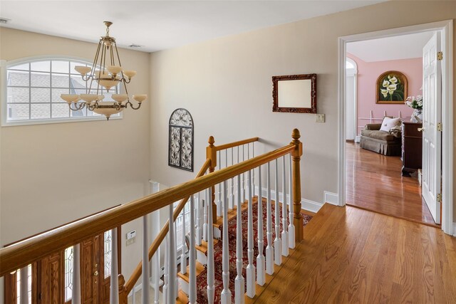 248 Delaware Ave, Island Park, NY 11558 - corridor with an upstairs landing, a chandelier, and wood finished floors