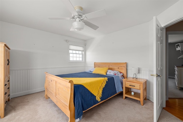 248 Delaware Ave, Island Park, NY 11558 - bedroom with wainscoting, carpet flooring, ceiling fan, and a baseboard heating unit