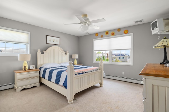 248 Delaware Ave, Island Park, NY 11558 - bedroom featuring baseboard heating, light colored carpet, an AC wall unit, and a ceiling fan
