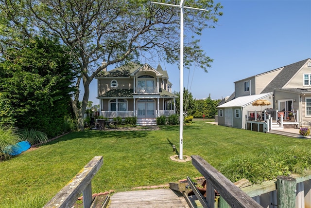 248 Delaware Ave, Island Park, NY 11558 - rear view of property featuring a lawn and a wooden deck