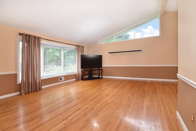 38 Balmoral Cres, White Plains, NY 10607 - unfurnished living room with lofted ceiling, light wood-style flooring, and plenty of natural light