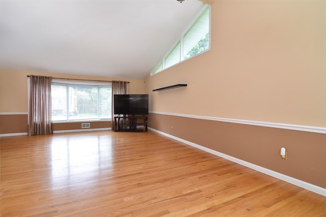 38 Balmoral Cres, White Plains, NY 10607 - unfurnished living room featuring lofted ceiling and light wood-style floors