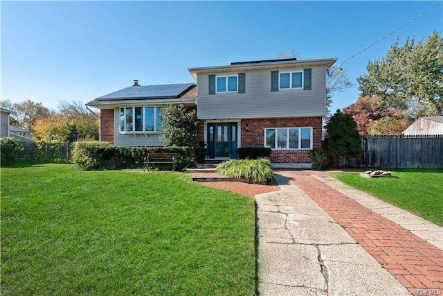 662 Interlaken Ln, North Babylon, NY 11703 - tri-level home with brick siding, solar panels, and driveway