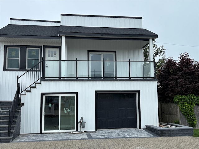 62 Clark St, Long Beach, NY 11561 - back of property featuring stairway, a shingled roof, and a balcony