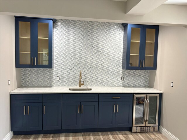 62 Clark St, Long Beach, NY 11561 - indoor bar featuring beverage cooler, tasteful backsplash, and light wood-style floors