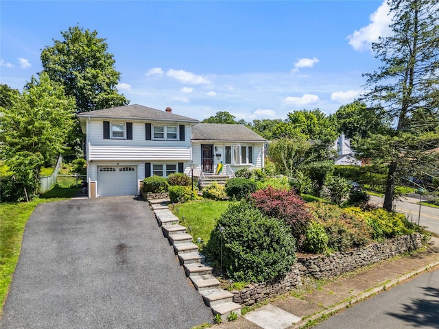 8 Valley View Ter, Suffern, NY 10901 - split level home featuring asphalt driveway, a garage, and a chimney