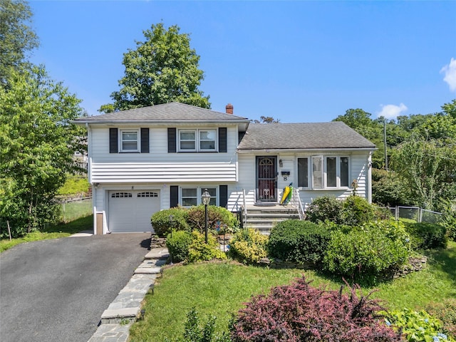 8 Valley View Ter, Suffern, NY 10901 - tri-level home featuring a garage, driveway, and a chimney