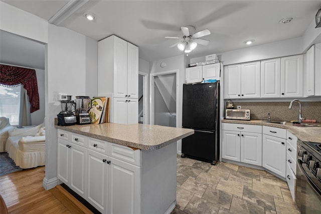8 Valley View Ter, Suffern, NY 10901 - kitchen with freestanding refrigerator, stove, ceiling fan, white cabinets, and recessed lighting
