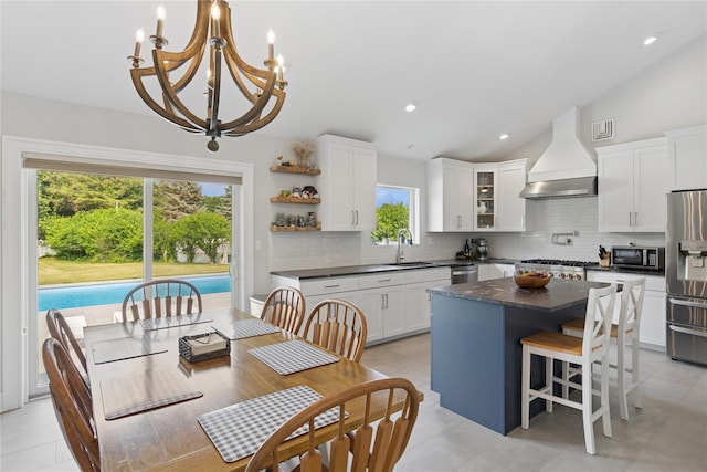 166 Williams Way S, Baiting Hollow, NY 11933 - kitchen with stainless steel appliances, premium range hood, dark countertops, lofted ceiling, and decorative backsplash