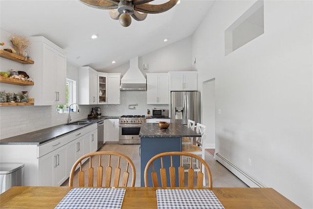 166 Williams Way S, Baiting Hollow, NY 11933 - kitchen featuring a baseboard heating unit, custom exhaust hood, stainless steel appliances, decorative backsplash, and a kitchen island