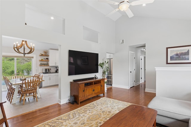 166 Williams Way S, Baiting Hollow, NY 11933 - living room featuring high vaulted ceiling, a chandelier, wood finished floors, and a ceiling fan