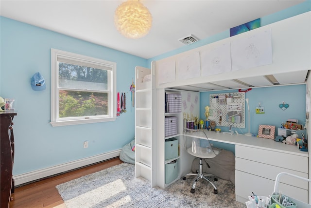 166 Williams Way S, Baiting Hollow, NY 11933 - bedroom with baseboard heating, wood finished floors, and built in desk