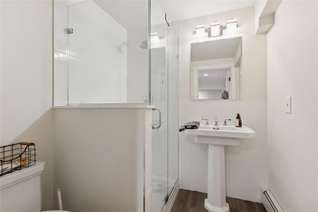 166 Williams Way S, Baiting Hollow, NY 11933 - bathroom with a baseboard radiator, wood finished floors, a stall shower, and tile walls