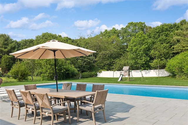 166 Williams Way S, Baiting Hollow, NY 11933 - view of swimming pool featuring a fenced backyard, outdoor dining space, a patio, a playground, and view of scattered trees