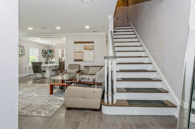 1 Howland Rd, East Rockaway, NY 11518 - staircase featuring ornamental molding, wood finished floors, and recessed lighting