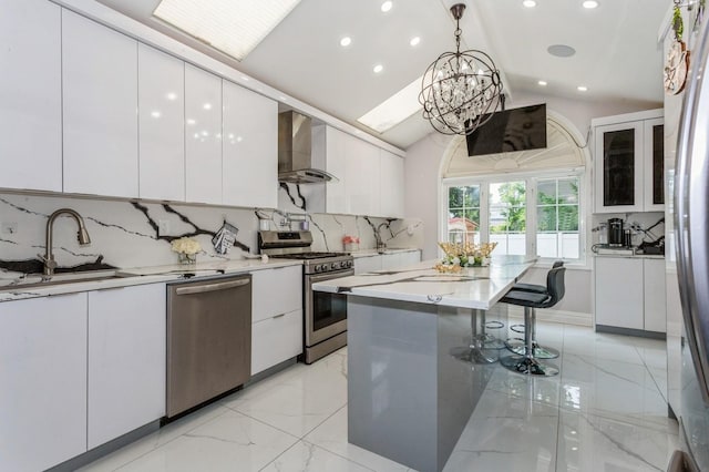 1 Howland Rd, East Rockaway, NY 11518 - kitchen featuring appliances with stainless steel finishes, wall chimney range hood, white cabinets, recessed lighting, and backsplash