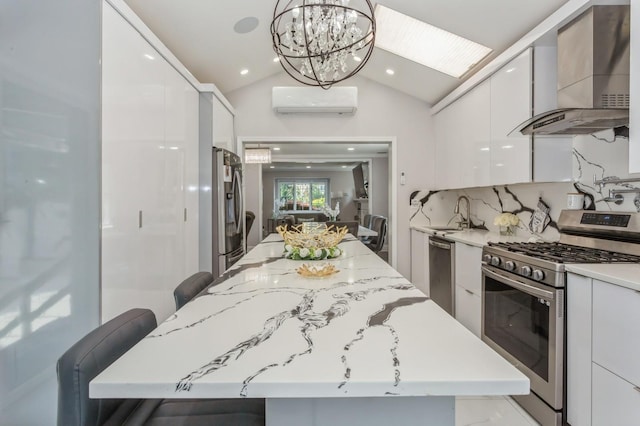 1 Howland Rd, East Rockaway, NY 11518 - kitchen featuring stainless steel appliances, wall chimney range hood, modern cabinets, a wall mounted AC, and white cabinets