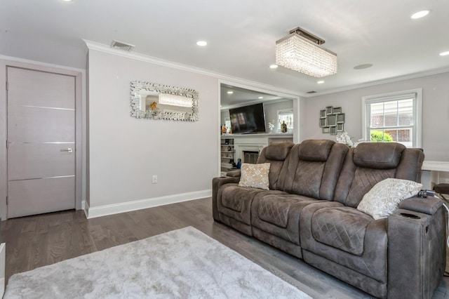 1 Howland Rd, East Rockaway, NY 11518 - living room with crown molding, wood finished floors, recessed lighting, and a glass covered fireplace