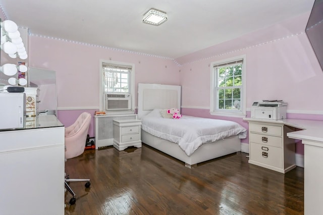 1 Howland Rd, East Rockaway, NY 11518 - bedroom with dark wood-style flooring, cooling unit, an office area, and radiator