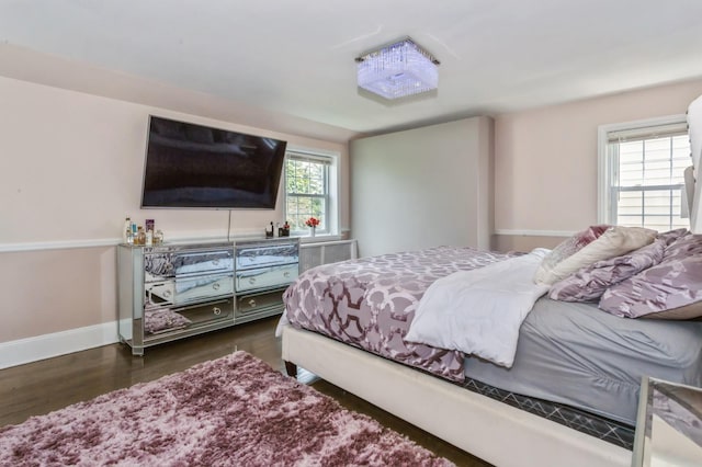 1 Howland Rd, East Rockaway, NY 11518 - bedroom featuring dark wood-style flooring and baseboards