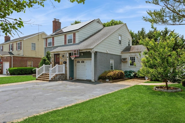 1 Howland Rd, East Rockaway, NY 11518 - view of front of house featuring a front yard, asphalt driveway, roof with shingles, and a garage