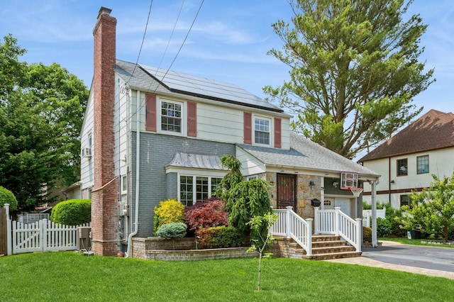 1 Howland Rd, East Rockaway, NY 11518 - view of front of property featuring a chimney, roof mounted solar panels, and roof with shingles