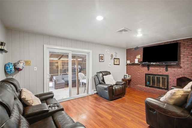 114 Cone Ave, Central Islip, NY 11722 - living area featuring a brick fireplace, light wood-type flooring, a baseboard radiator, and recessed lighting