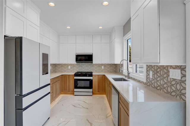10 Locust St, Hicksville, NY 11801 - kitchen with stainless steel appliances, light marble finish flooring, recessed lighting, light stone countertops, and white cabinetry