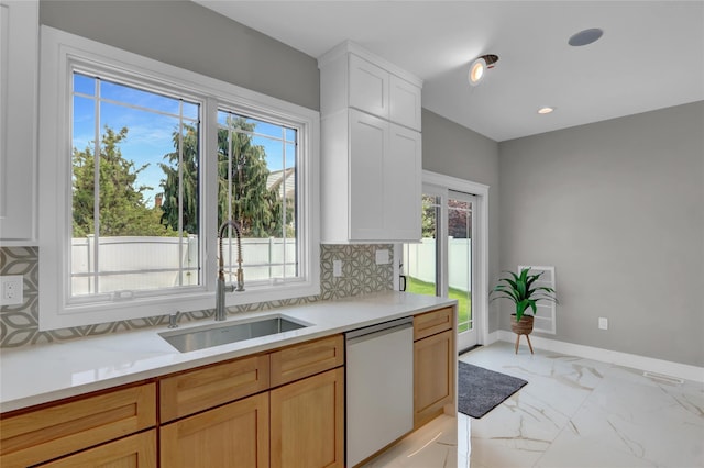 10 Locust St, Hicksville, NY 11801 - kitchen with dishwashing machine, light countertops, decorative backsplash, light marble finish flooring, and white cabinets