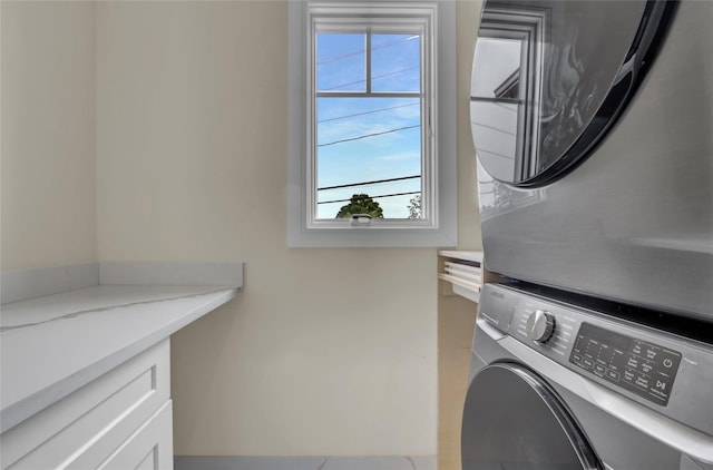 10 Locust St, Hicksville, NY 11801 - washroom featuring stacked washer / dryer and cabinet space