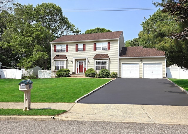 54 Gatelot Ave, Lake Ronkonkoma, NY 11779 - colonial house with an attached garage and asphalt driveway