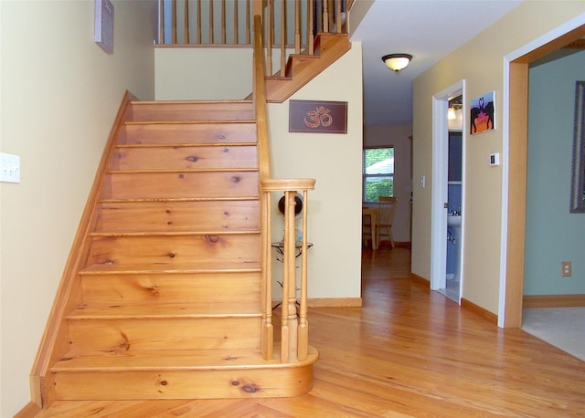 54 Gatelot Ave, Lake Ronkonkoma, NY 11779 - stairway with wood finished floors and baseboards