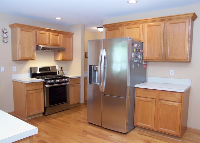 54 Gatelot Ave, Lake Ronkonkoma, NY 11779 - kitchen with appliances with stainless steel finishes, under cabinet range hood, light countertops, light wood-type flooring, and recessed lighting