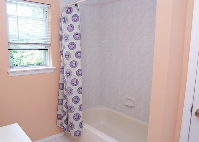 54 Gatelot Ave, Lake Ronkonkoma, NY 11779 - bathroom featuring shower / tub combo with curtain and baseboards