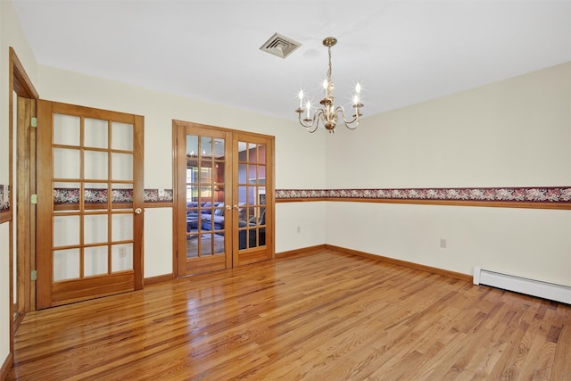 561 Toleman Rd, Rock Tavern, NY 12575 - empty room featuring french doors, light wood-style flooring, a baseboard heating unit, and a chandelier
