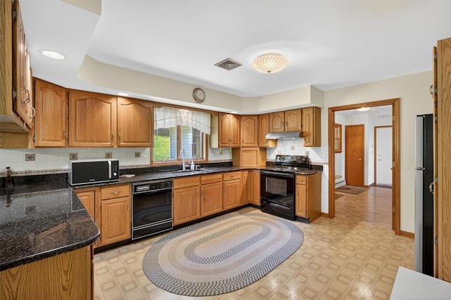 561 Toleman Rd, Rock Tavern, NY 12575 - kitchen featuring black appliances, light floors, under cabinet range hood, brown cabinetry, and recessed lighting